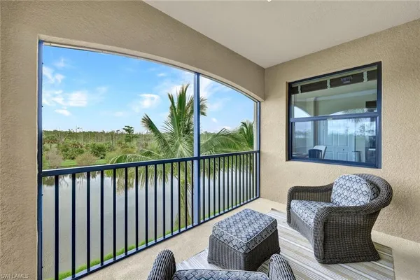 a balcony with furniture and a potted plant