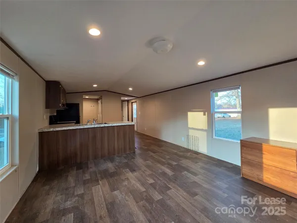 a view of a room with wooden floor
