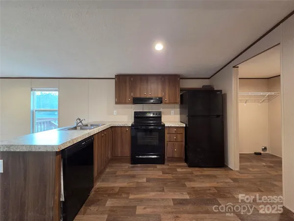 a kitchen with granite countertop a refrigerator and a stove