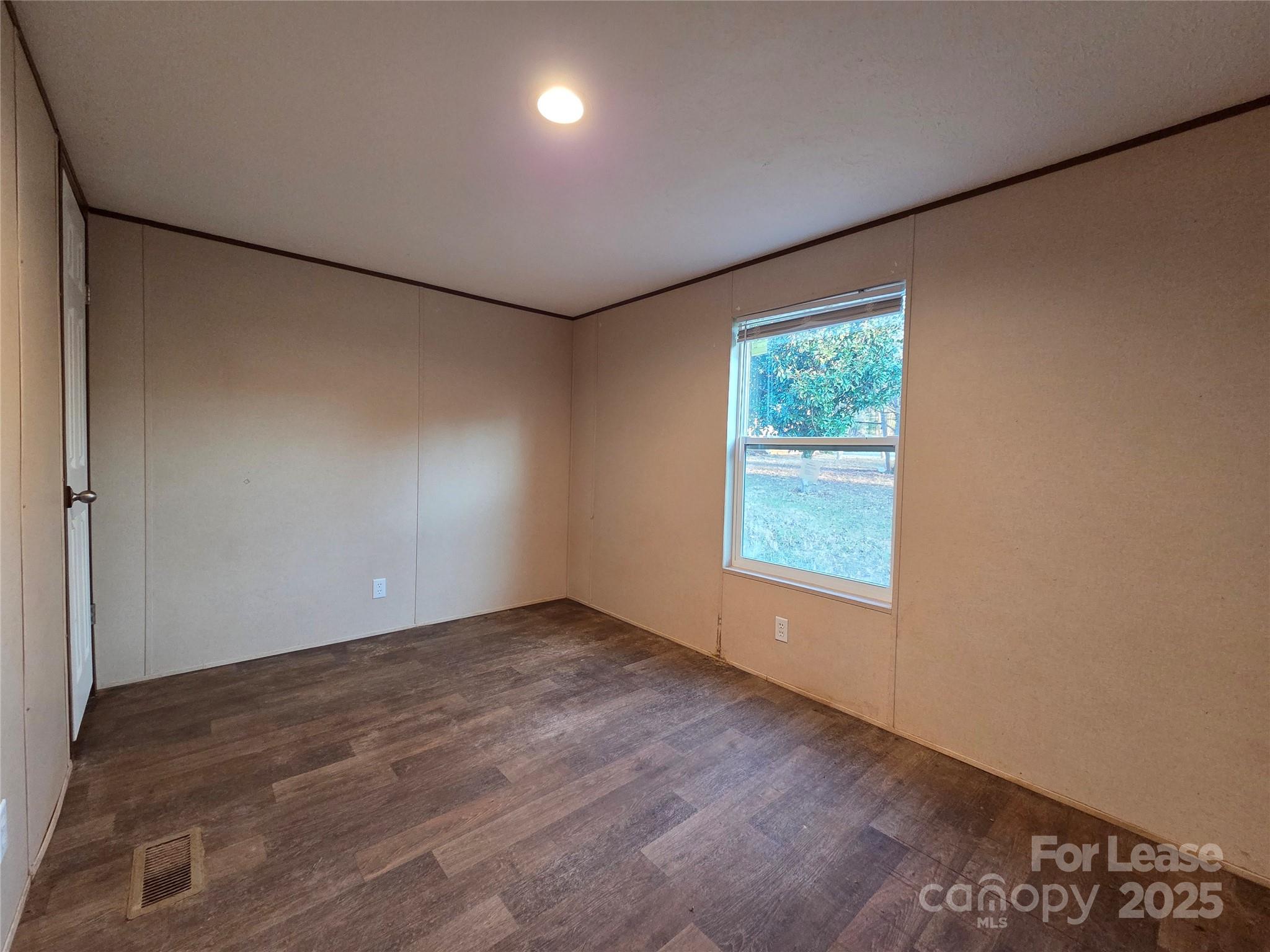 2329 Rufus Ratchford Road Gastonia, NC 28056 - Photo 10 of 10 an empty room with wooden floor and windows