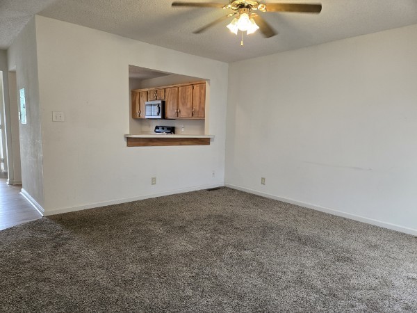 235 State Line Road Oak Grove, KY 42262 - Photo 8 of 18 an empty room with a chandelier fan and windows