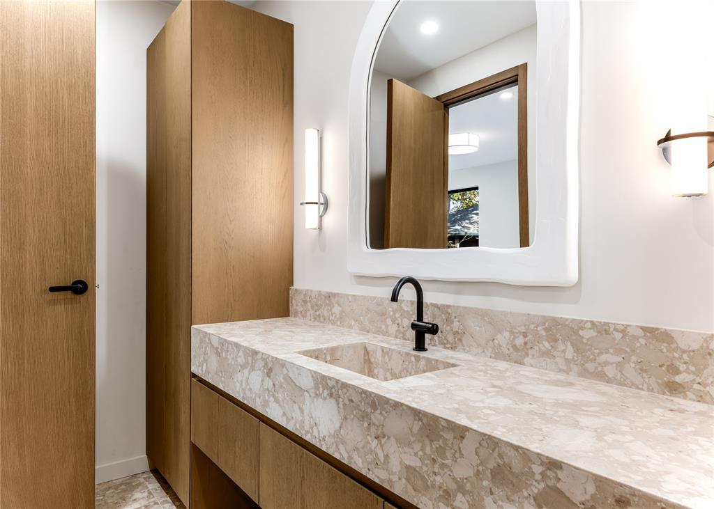 6145 Llano Avenue Dallas, TX 75214 - Photo 33 of 40 a bathroom with a sink and a mirror