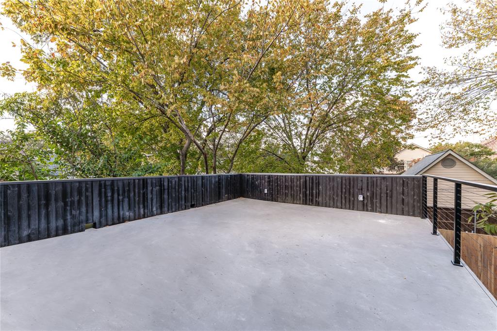 6145 Llano Avenue Dallas, TX 75214 - Photo 38 of 40 a view of backyard with wooden fence and trees