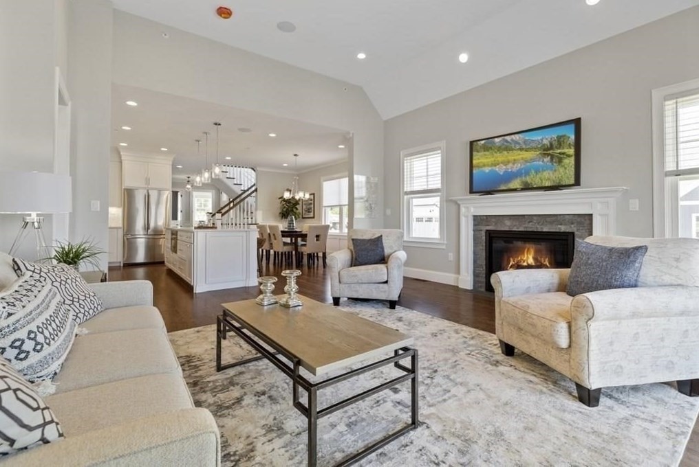 30 Waterville Lane, Unit 30 Hopkinton, MA 01748 - Photo 4 of 22 a living room with furniture a table and a fireplace
