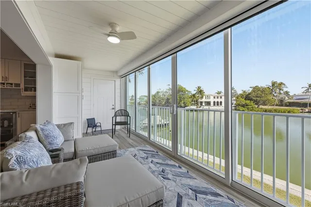 a living room with furniture and a floor to ceiling window