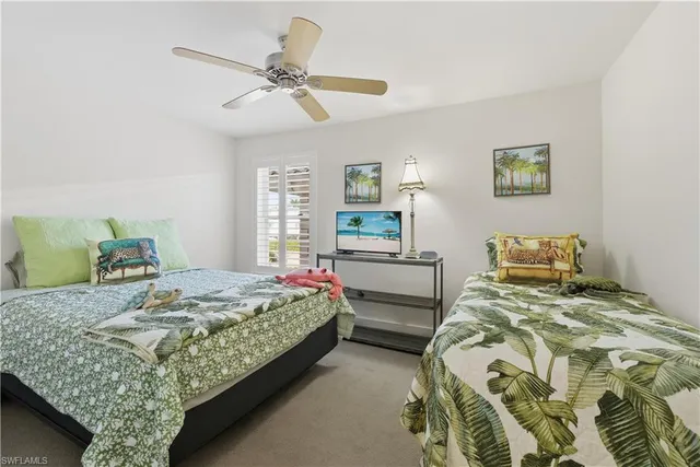 a bedroom with two beds and a table