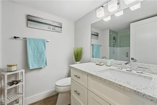 a bathroom with a sink a toilet and mirror