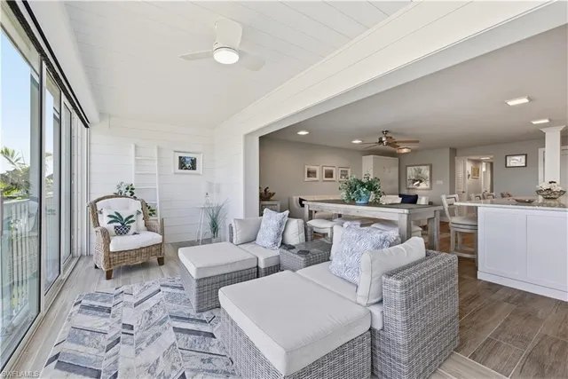 a living room with furniture and a view of kitchen