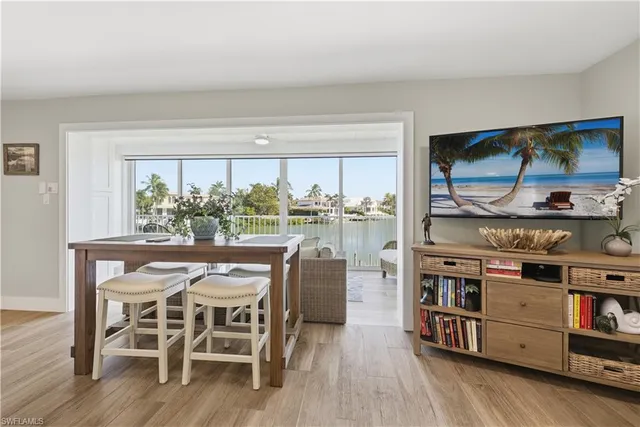 a dining room with furniture and wooden floor