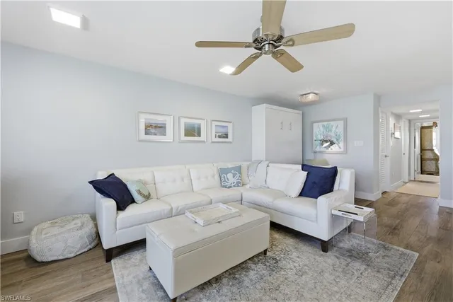 a living room with furniture and a ceiling fan