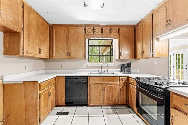 a kitchen with stainless steel appliances granite countertop a stove sink and cabinets