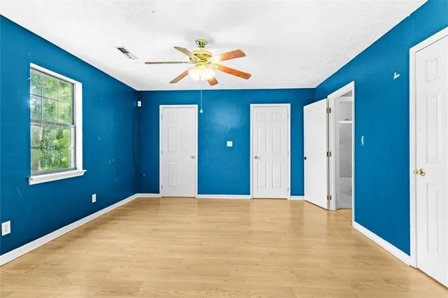 a view of a livingroom with a chandelier fan and a large window