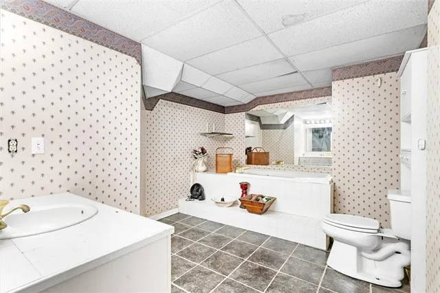 a view of a room with a wooden floor and cabinets