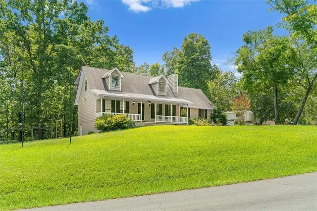 a front view of a house with a garden