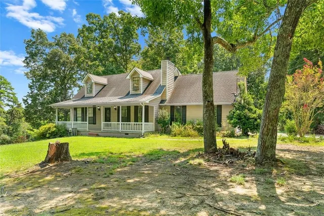 a view of a house with a yard patio and swimming pool