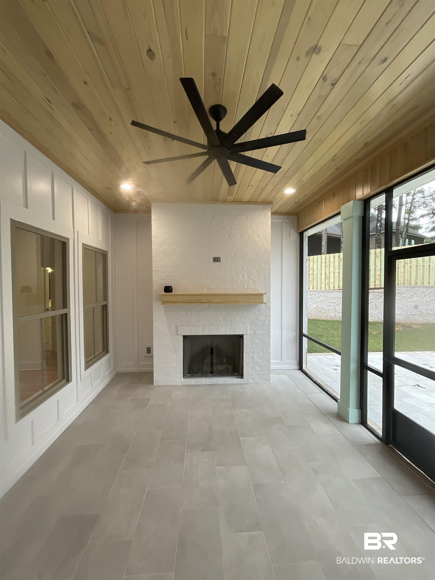 6389 Garrison Drive Daphne, AL 36527 - Photo 3 of 5 Unfurnished sunroom featuring ceiling fan, a fireplace, and wood ceiling