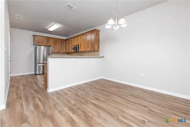 a view of a kitchen from the hallway