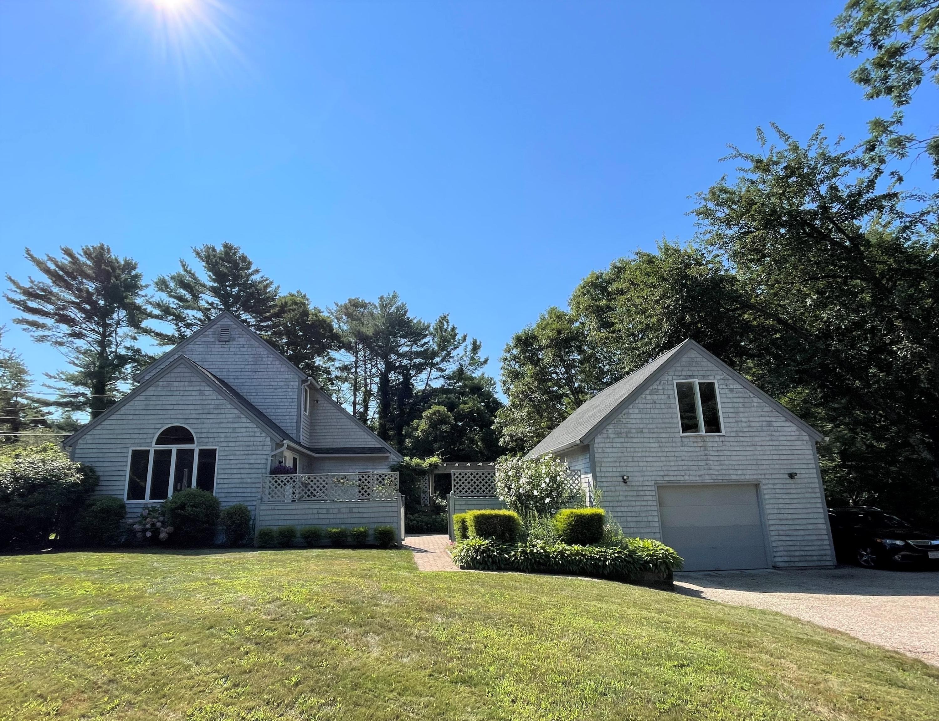 174 Tanglewood Drive Osterville, MA 02655 - Photo 29 of 34 a front view of a house with a yard and garage