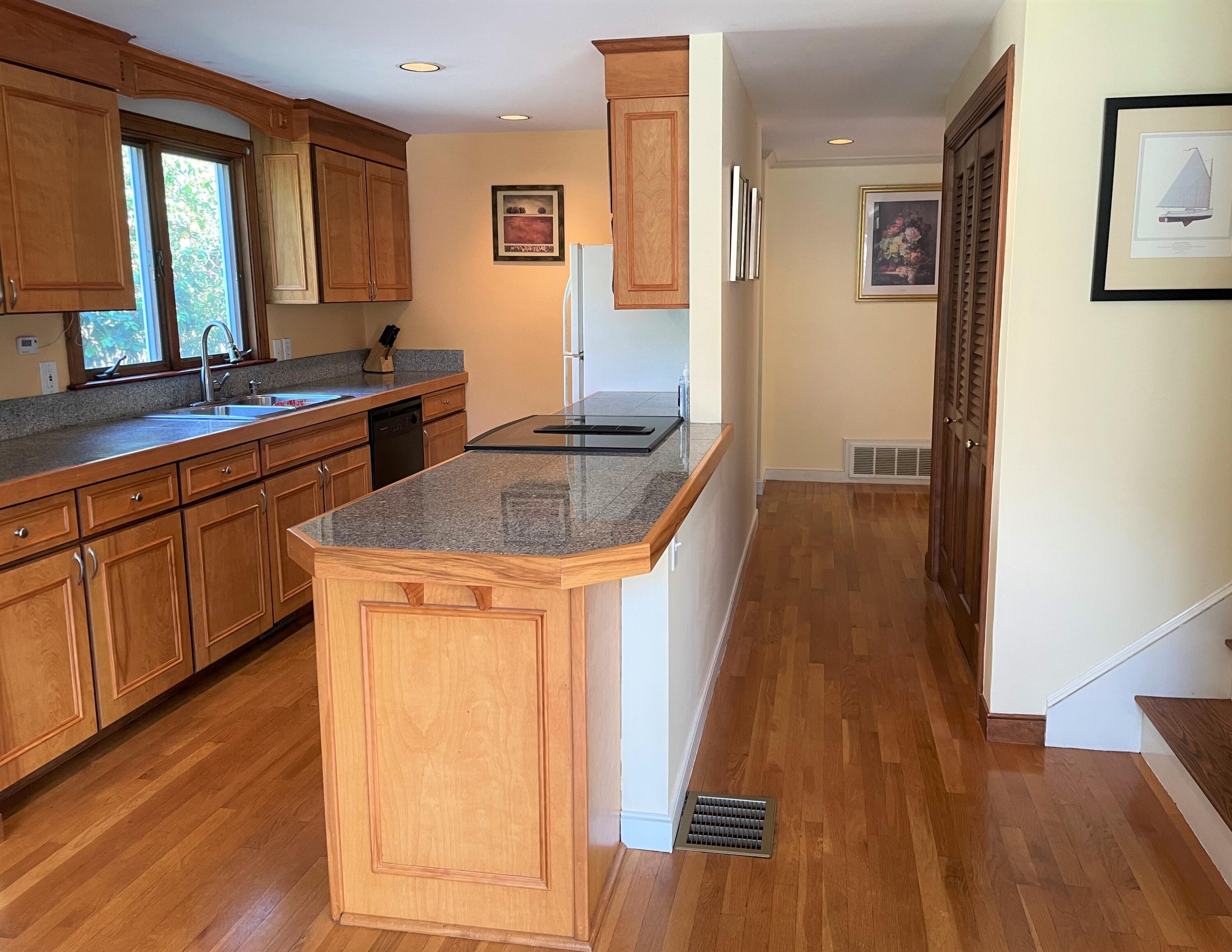 174 Tanglewood Drive Osterville, MA 02655 - Photo 8 of 34 a kitchen with stainless steel appliances granite countertop a sink stove and wooden floor