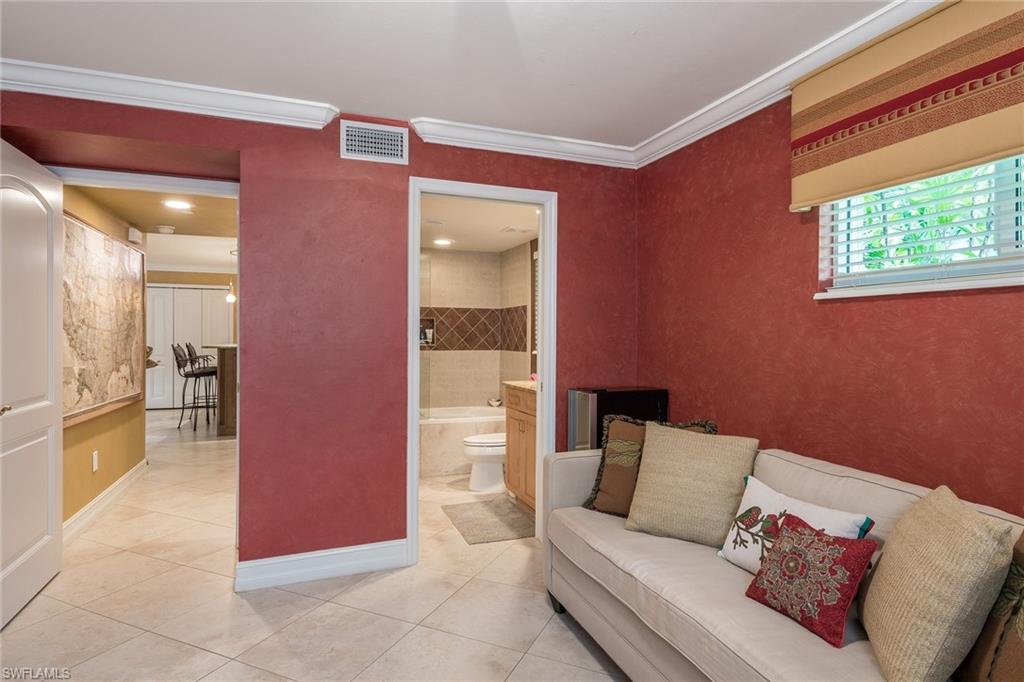 445 3rd Avenue South, Unit 102 Naples, FL 34102 - Photo 11 of 26 a living room with furniture and a window