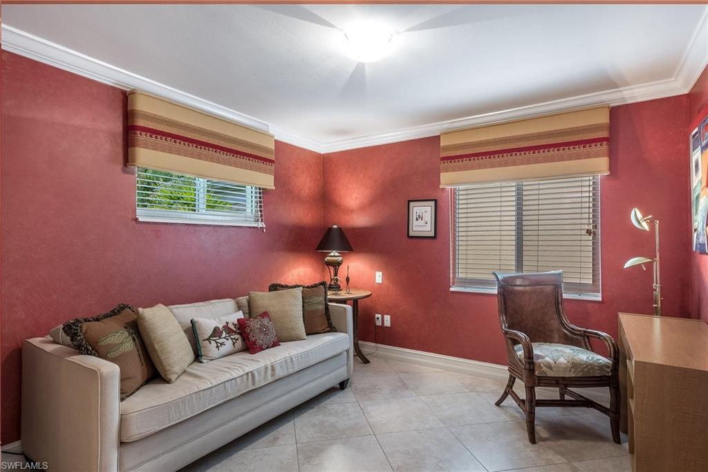 445 3rd Avenue South, Unit 102 Naples, FL 34102 - Photo 12 of 26 a living room with furniture and a window