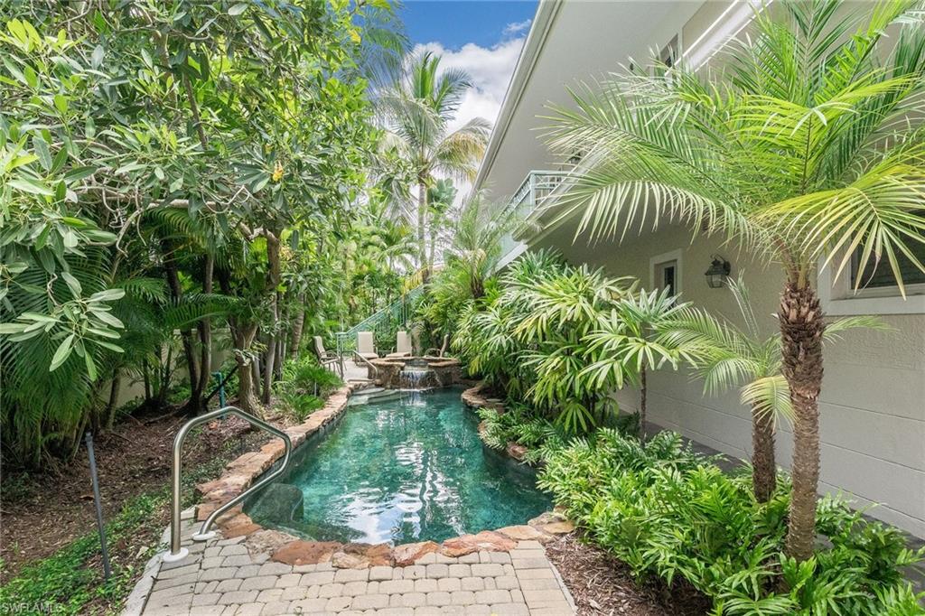 445 3rd Avenue South, Unit 102 Naples, FL 34102 - Photo 18 of 26 a backyard of a house with outdoor seating and plants