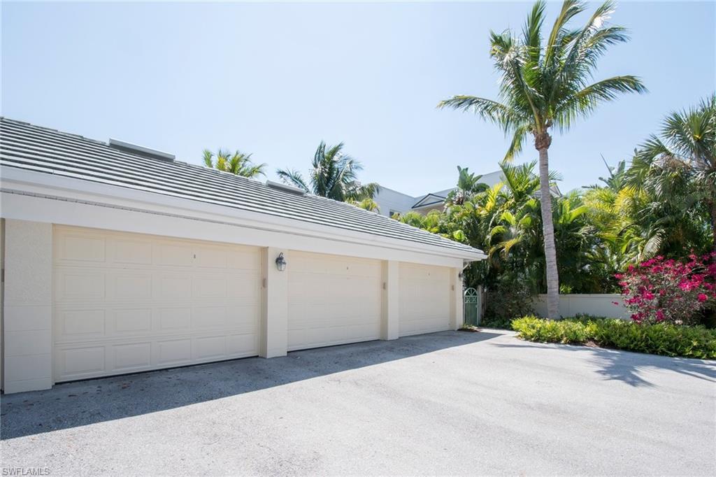 445 3rd Avenue South, Unit 102 Naples, FL 34102 - Photo 19 of 26 a front view of a house with a garage
