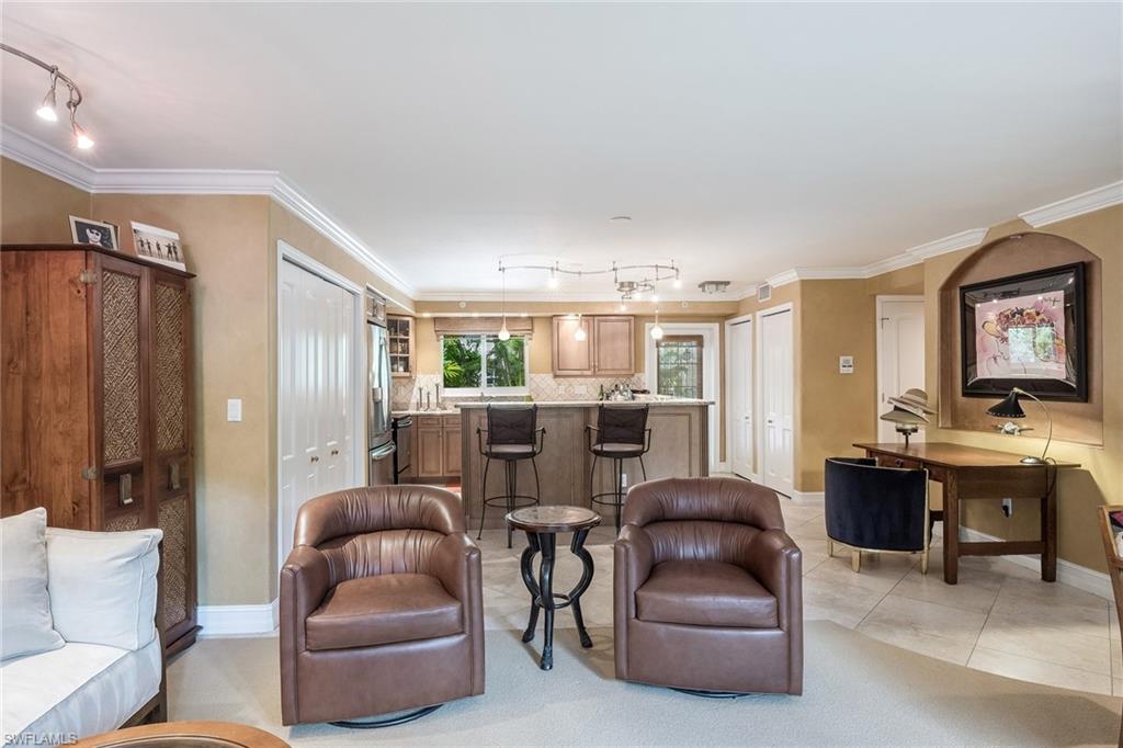 445 3rd Avenue South, Unit 102 Naples, FL 34102 - Photo 7 of 26 a living room with furniture kitchen view and a large window