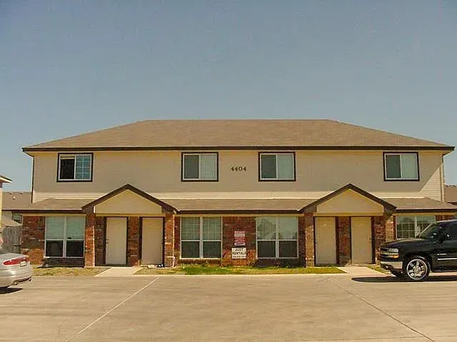a car parked in front of a white building