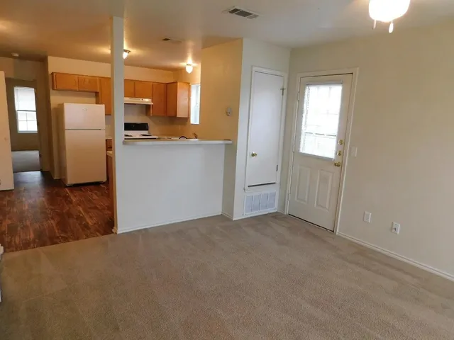 a view of a kitchen with a refrigerator a sink and a dishwasher