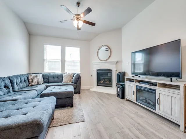 a living room with furniture and kitchen view