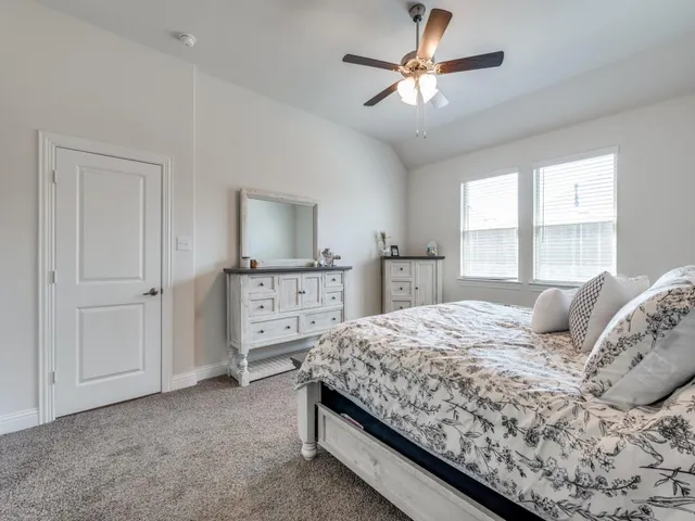 a bedroom with a bed and a dresser