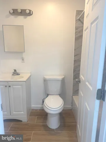 a white toilet sitting next to a bathroom sink