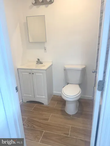 a white toilet sitting next to a bathroom sink