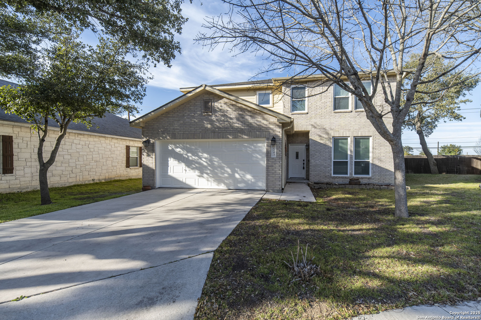 2243 Sunderidge San Antonio, TX 78260 - Photo 1 of 45 a view of a yard in front of a house with a large tree