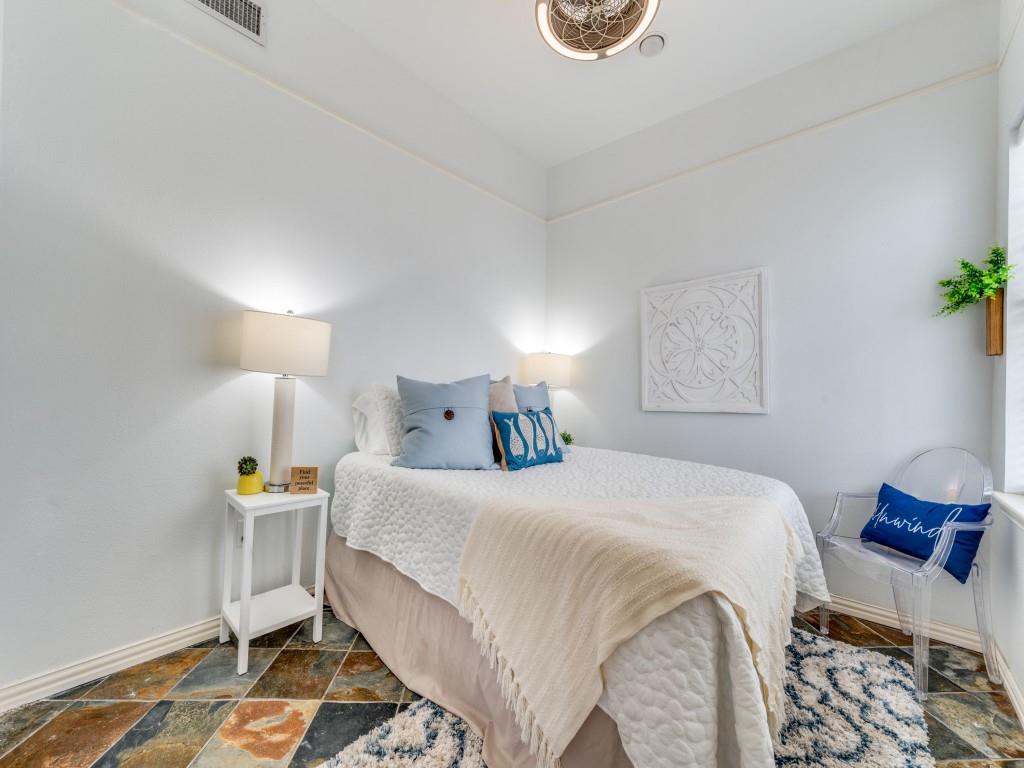 41 White Oak Road Gainesville, TX 76240 - Photo 19 of 38 a bedroom with a bed and wooden floor