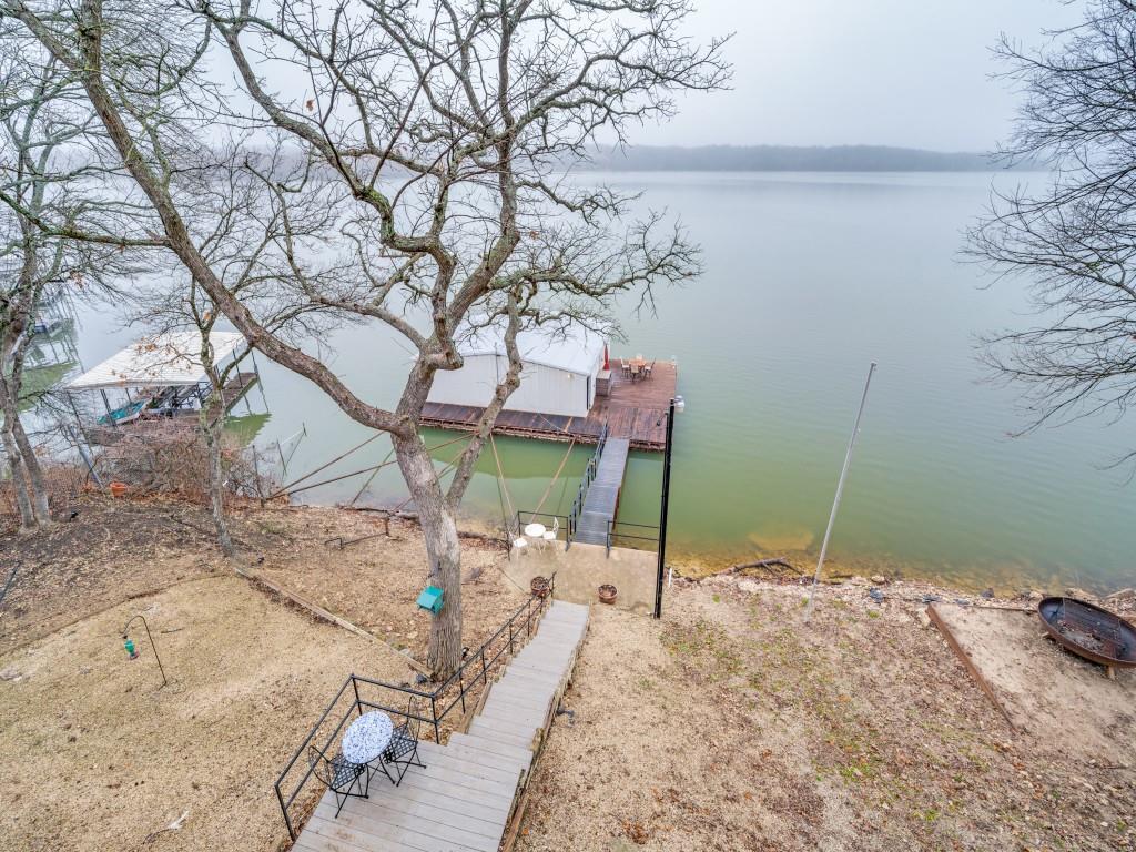 41 White Oak Road Gainesville, TX 76240 - Photo 25 of 38 a backyard of a house with table and chairs