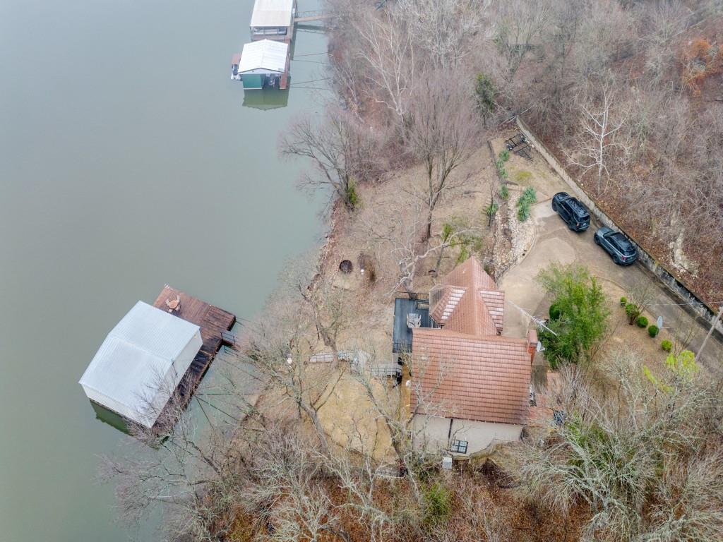 41 White Oak Road Gainesville, TX 76240 - Photo 36 of 38 an aerial view of a house with a yard and trees