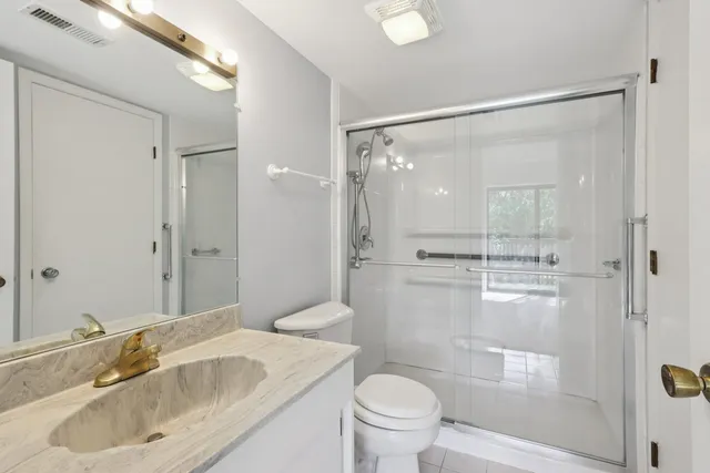 a bathroom with a sink toilet and shower