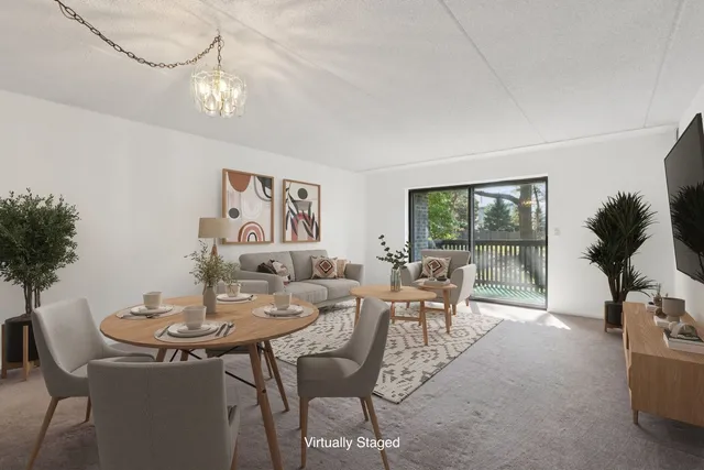 a view of a dining room with furniture and a potted plant