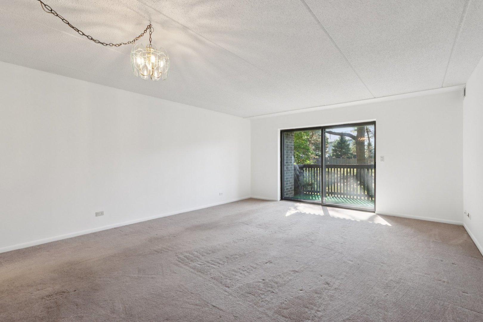 920 Vose Drive, Unit 106 Gurnee, IL 60031 - Photo 8 of 39 a view of an empty room with a window
