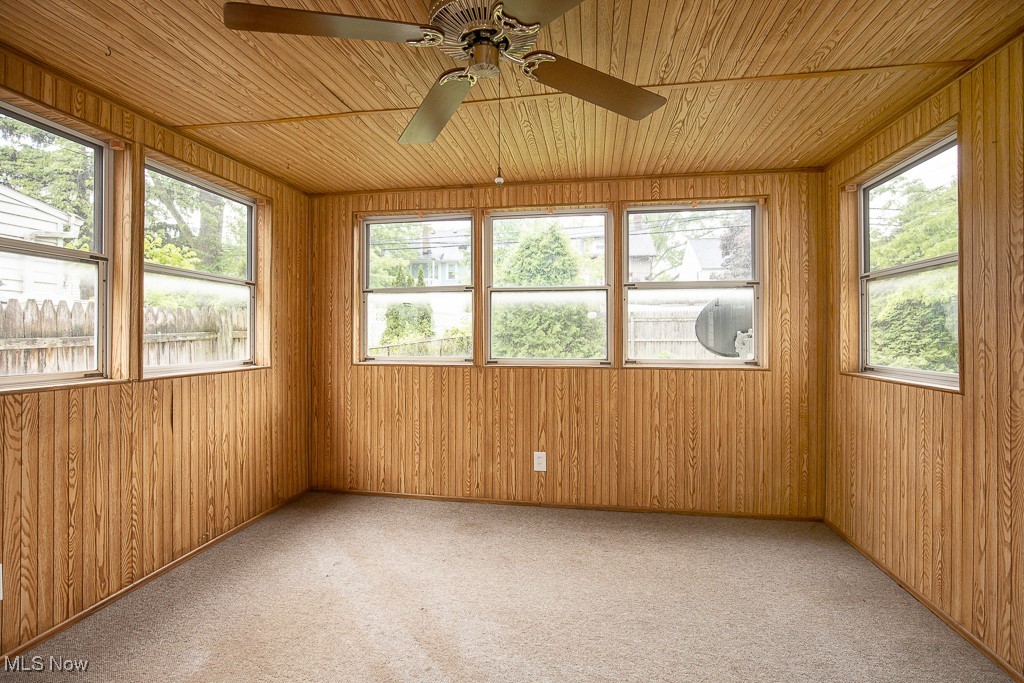 3762 Covington Road South Euclid, OH 44121 - Photo 28 of 31 Unfurnished sunroom featuring wooden ceiling, carpet flooring, and wooden walls