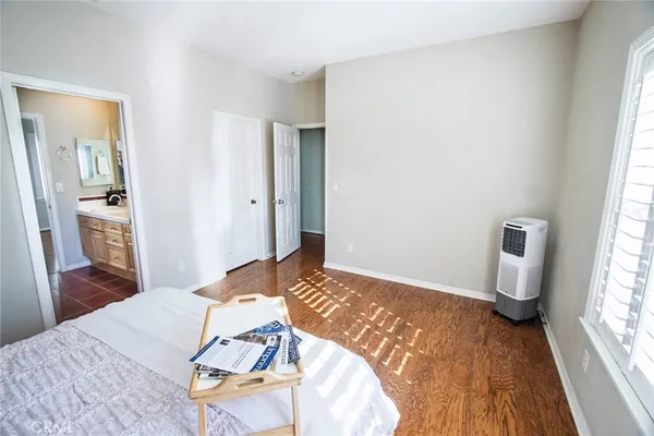 a bedroom with a bed and a large window