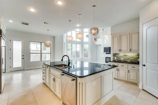 a kitchen with granite countertop a sink and cabinets