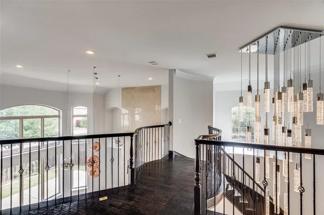 a view of a hallway with a large window and stairs