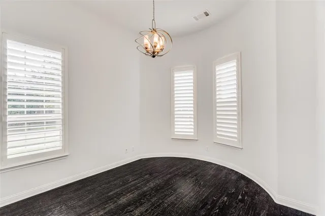a view of a bedroom with a bed and a window