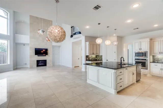 a kitchen with stainless steel appliances granite countertop a sink and cabinets