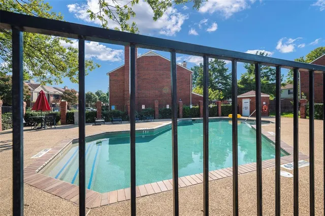 a front view of a house with a garden and tree