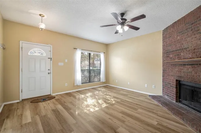 wooden floor in an empty room with a fireplace