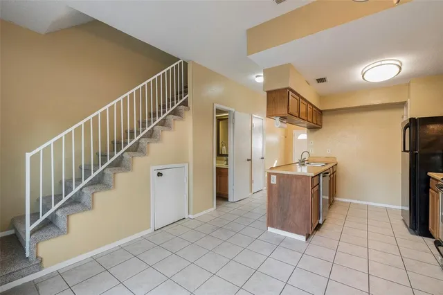 a view of a kitchen with closet and electronic appliances